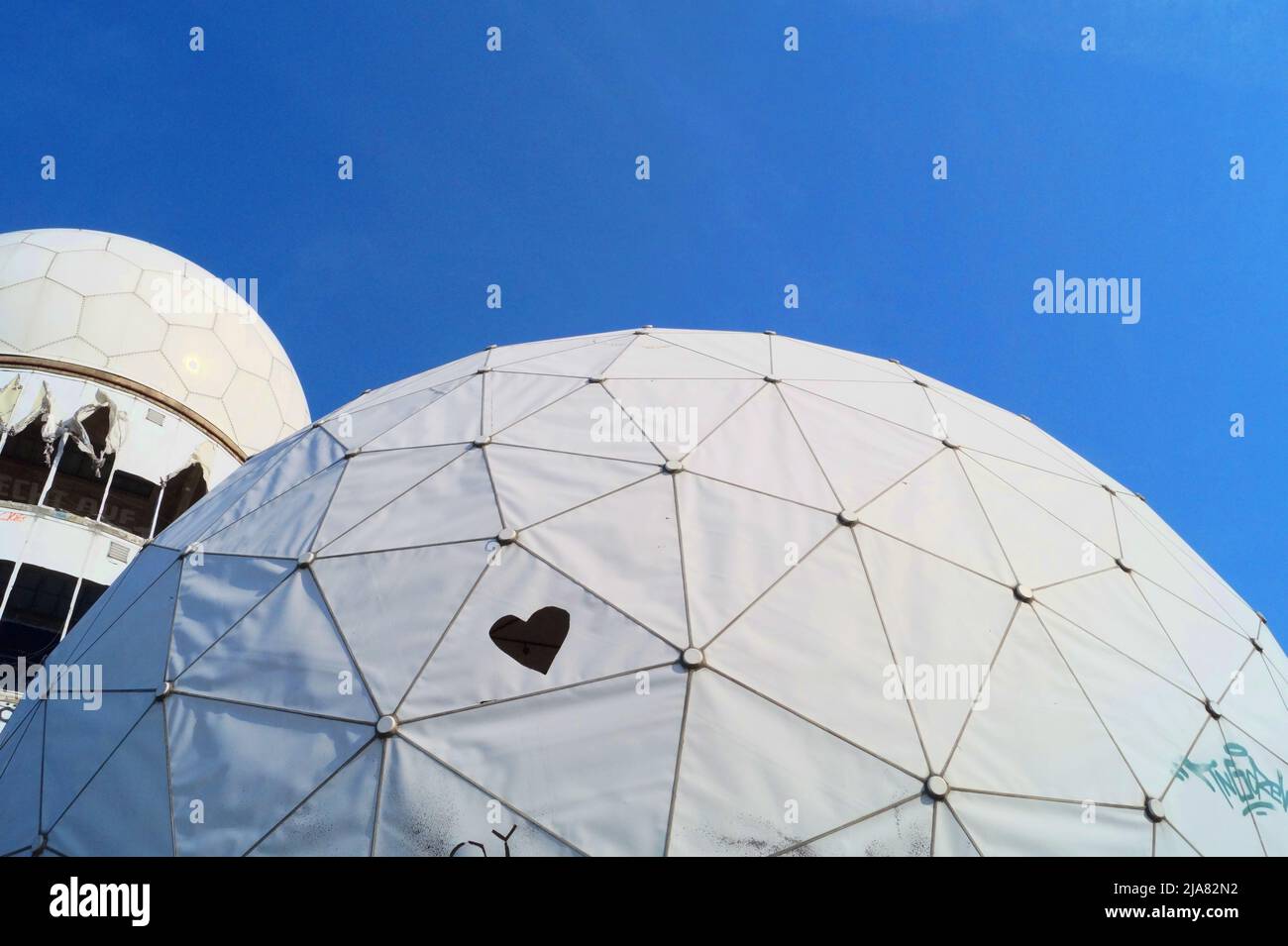 two domes from Teufelsberg Berlin with heart graffiti in front of blue sky Stock Photo