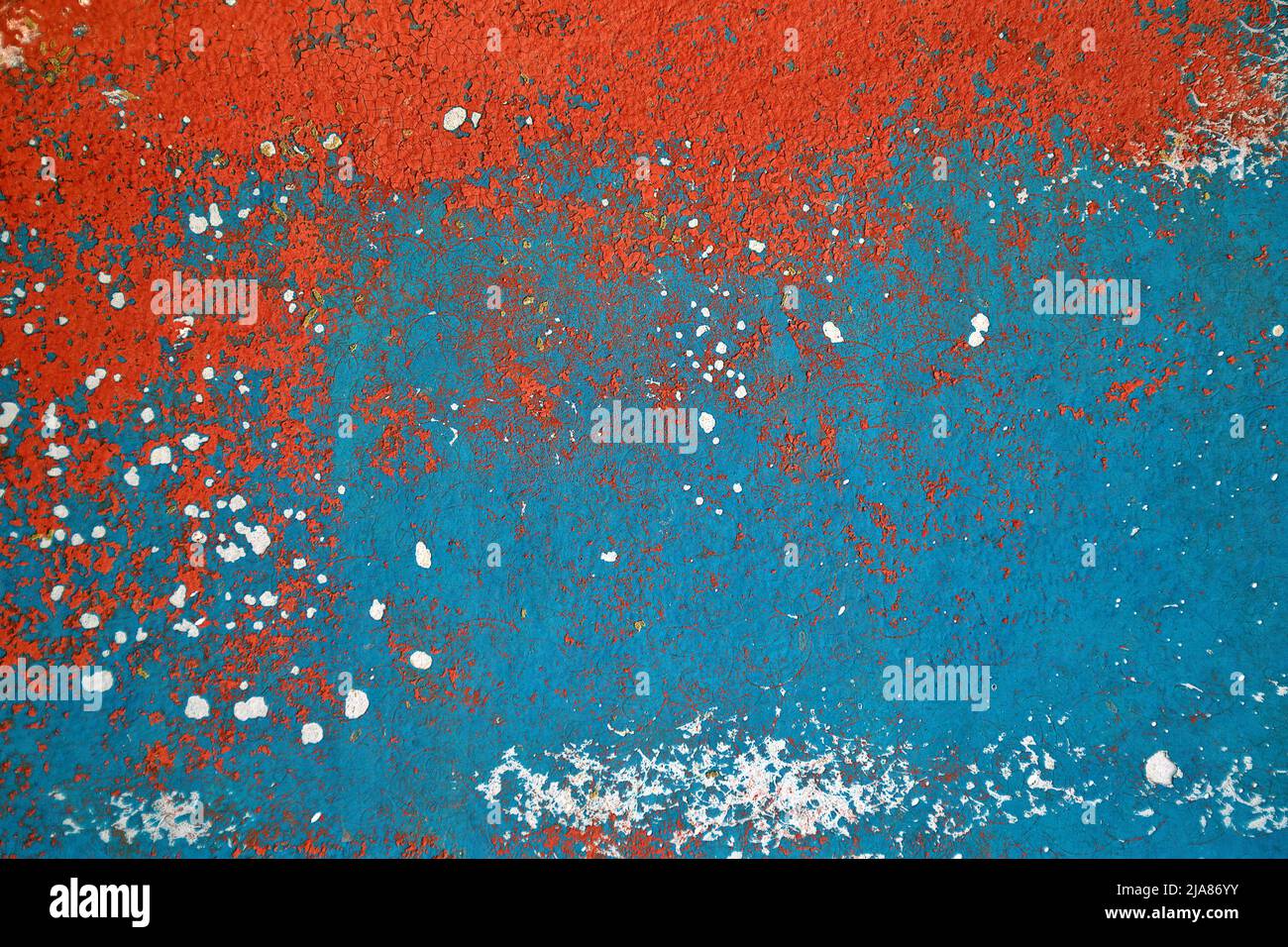 Orange and turquoise distressed paint abstract with white chips Stock Photo