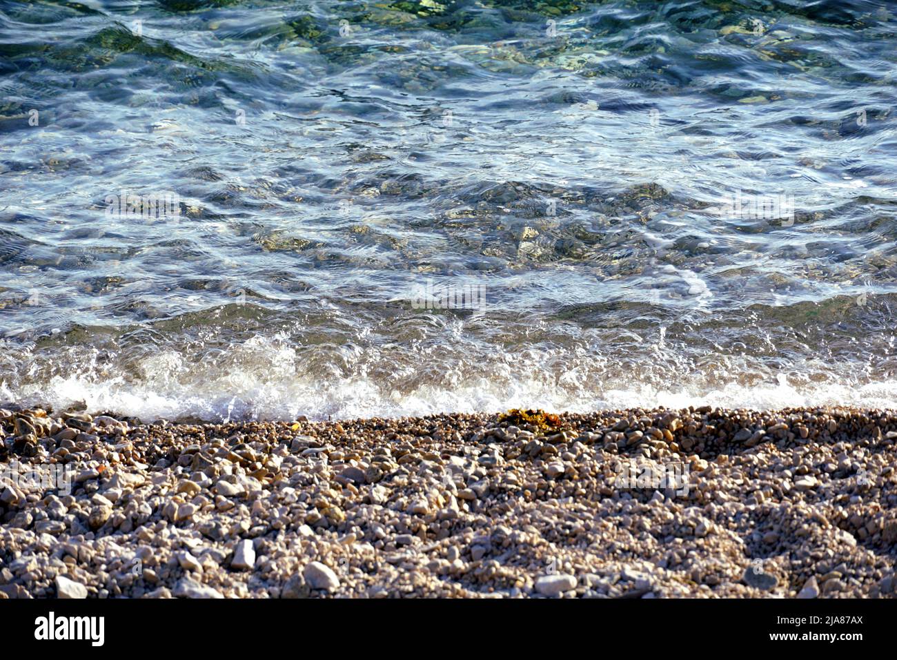 Beautiful crystal clear transparent rippled sea water Stock Photo