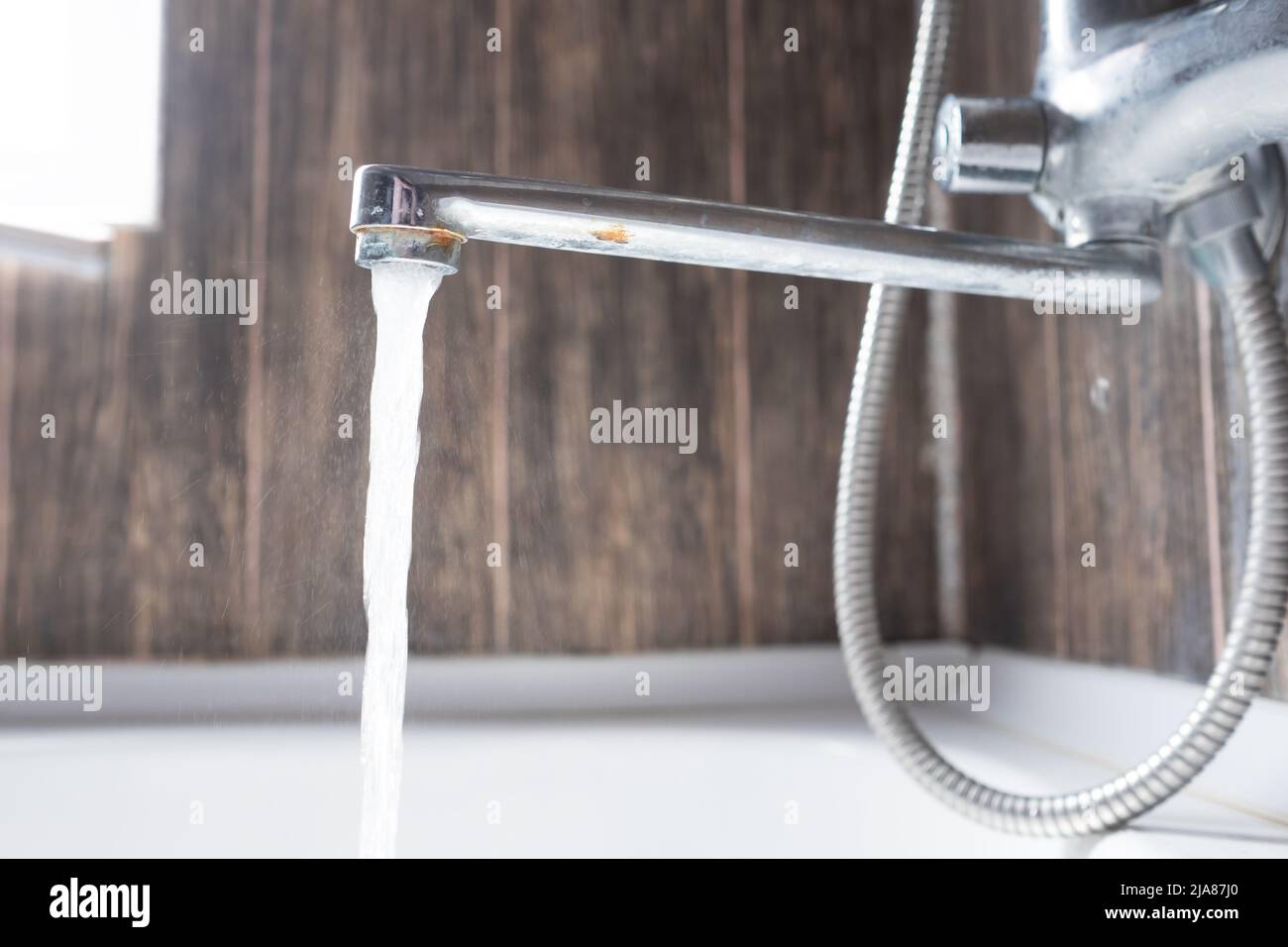 faucet with flowing water in wash sink. Somebody to turn off