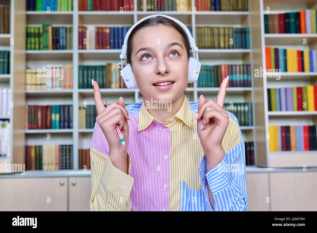 Talking teenage girl in headphones looking at webcam Stock Photo - Alamy