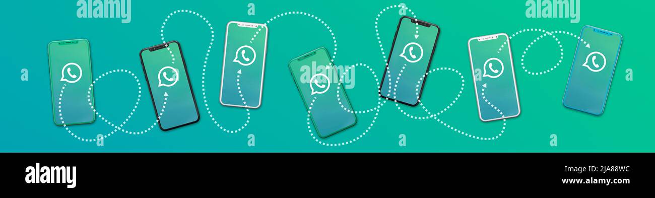 ROSARIO, ARGENTINA - MAY 28, 2022: Concept of communication between many smartphones with whatsapp messenger app. Stock Photo