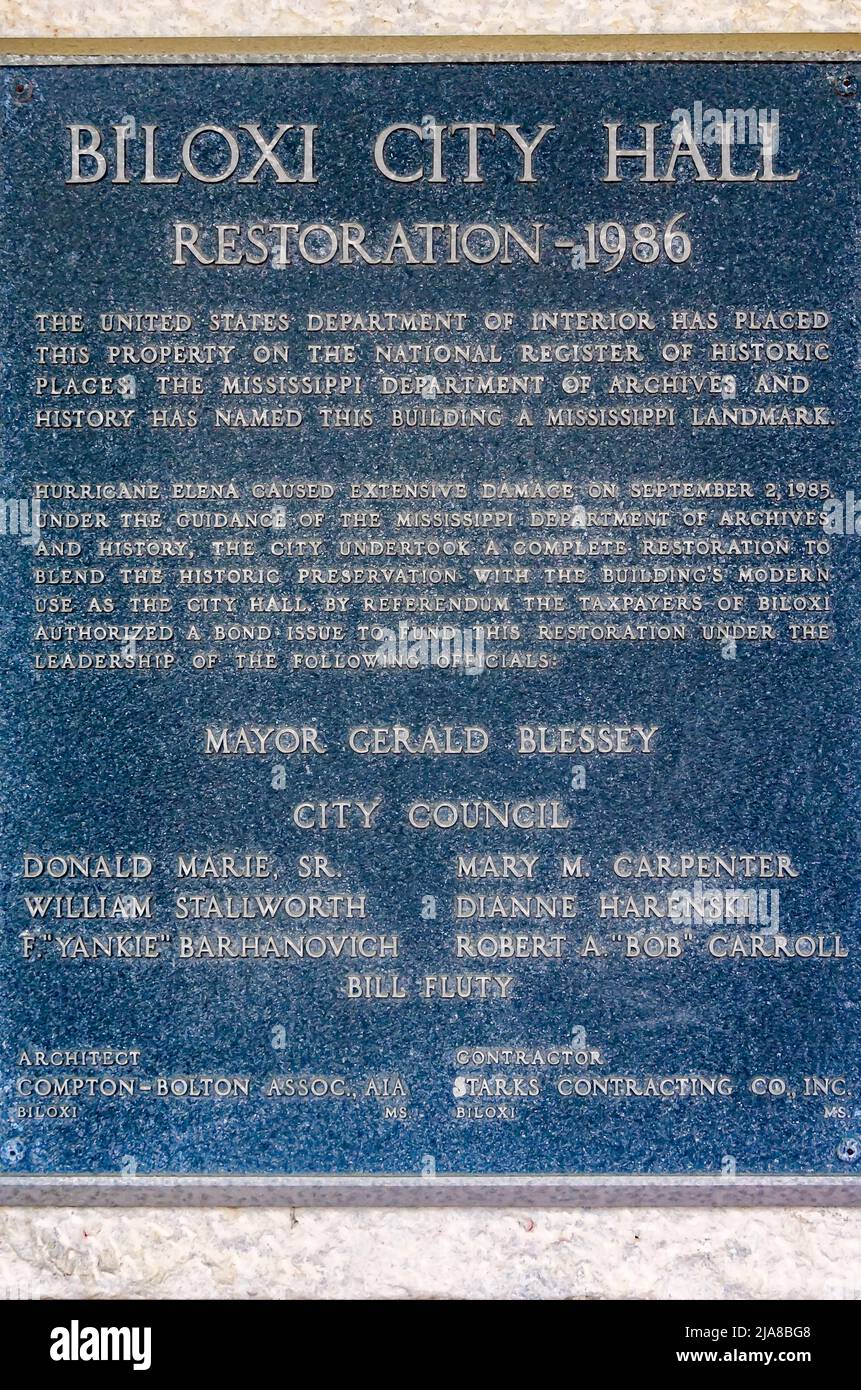A plaque details the 1986 restoration of Biloxi City Hall on Lameuse