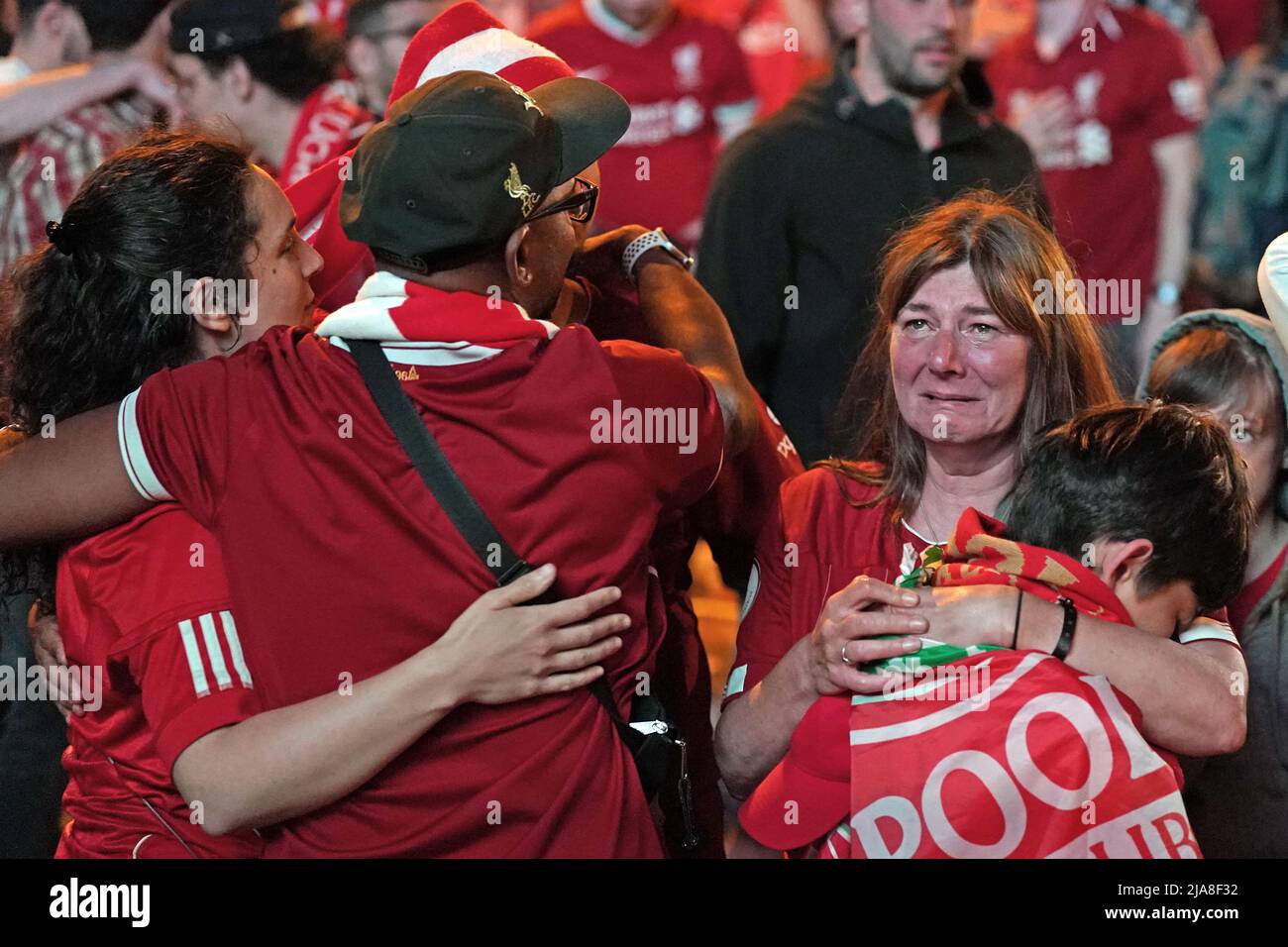 Liverpool fans in the fanzone in Paris, react after seeing their team