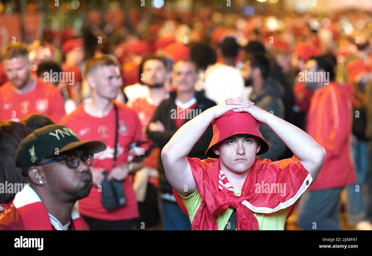 Liverpool fans in the fanzone in Paris, react after seeing their team