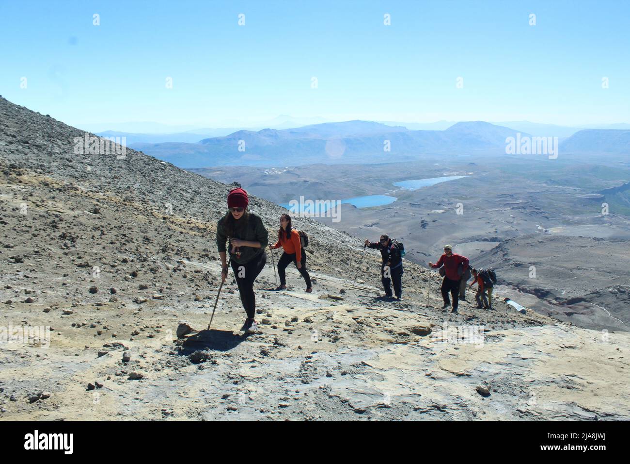 Group of people going up a montain Stock Photo