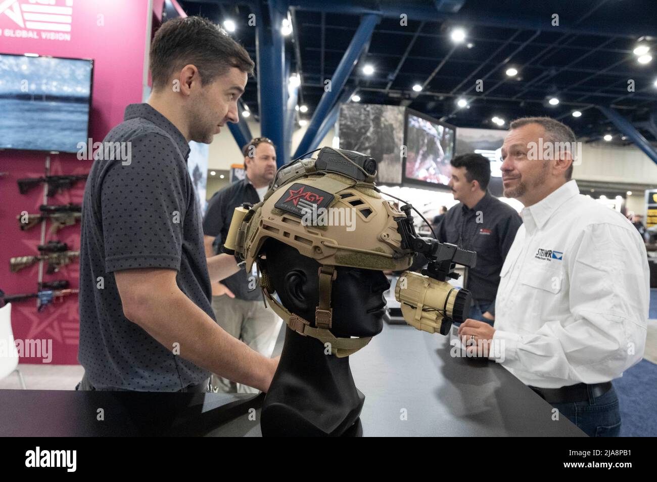 Houston, Texas United States, 28th May 2022: Gun enthusiast talks with a salesperson at the AGM booth on Saturday morning at the National Rifle Association's (NRA) trade show. The exhibits cover almost 14 acres inside the George R. Brown Convention Center. Credit: Bob Daemmrich/Alamy Live News Stock Photo