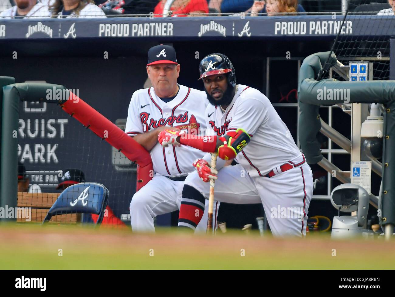 Atlanta, GA, USA. 28th May, 2022. Atlanta Braves manager Brian Snitker  (left) and outfielder Marcell Ozuna (right) watch from the dugout during  the ninth inning of a MLB game against the Miami