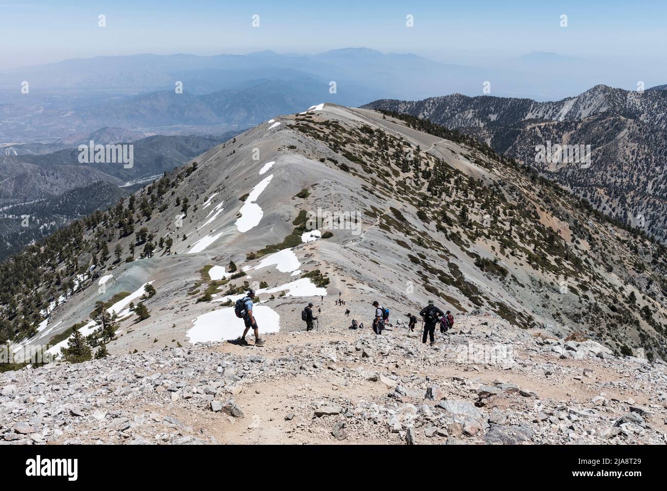 Mt Baldy, California, USA - May 22, 2022:  Hikers descending the Devils Backbone Trail on Mt Baldy in the San Gabriel Mountains near Los Angeles and O Stock Photo
