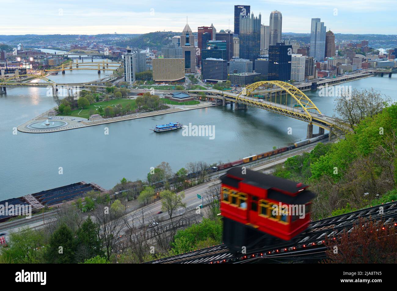 The funicular climbs a hill with the Pittsburgh skyline behind it. Stock Photo
