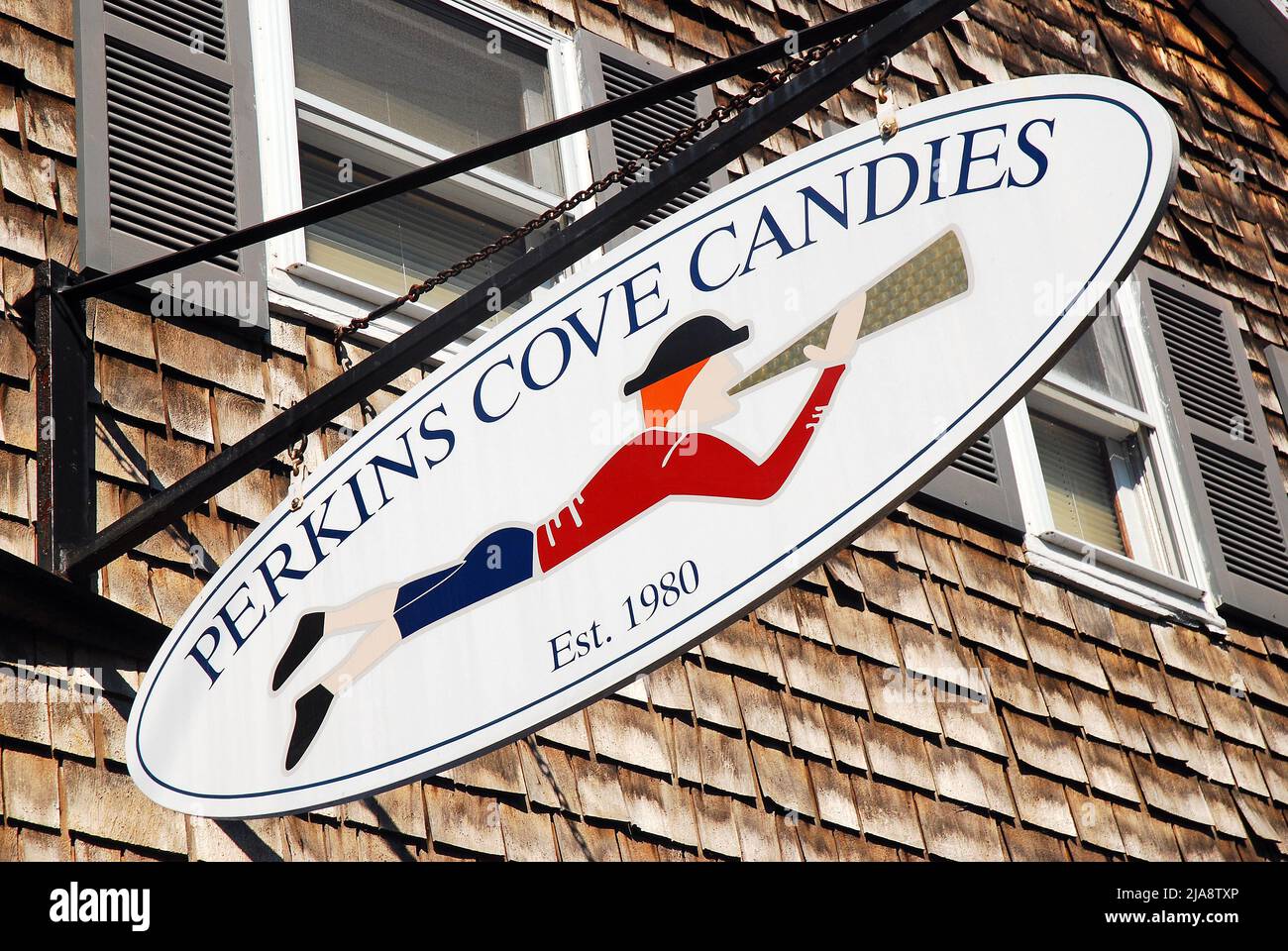 A cute colonial style sign hangs over a candy store in Ogunquit, Maine