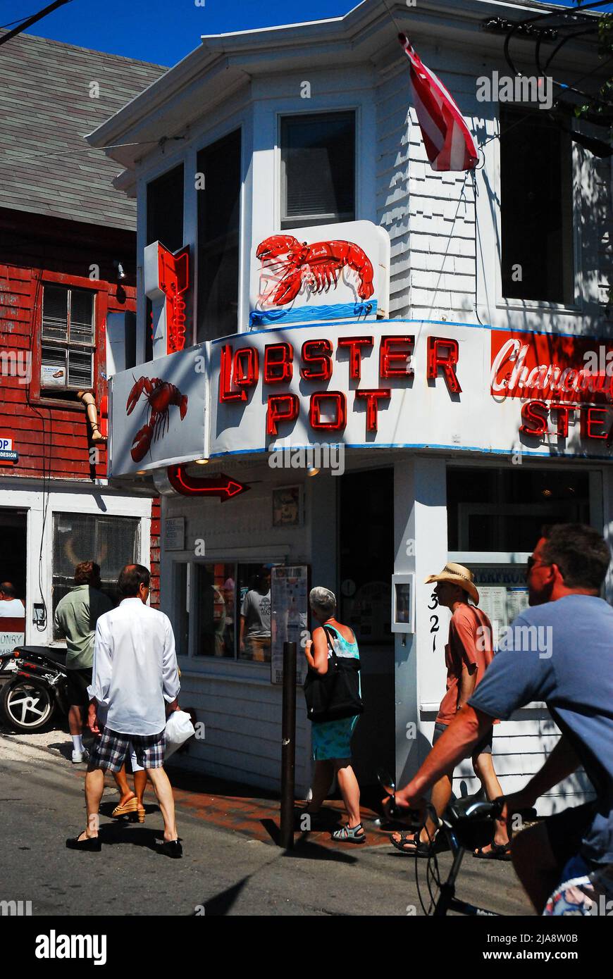 A summer crowd passes in front of the Lobster House in Provincetown, Cape Cod, Massachusetts Stock Photo