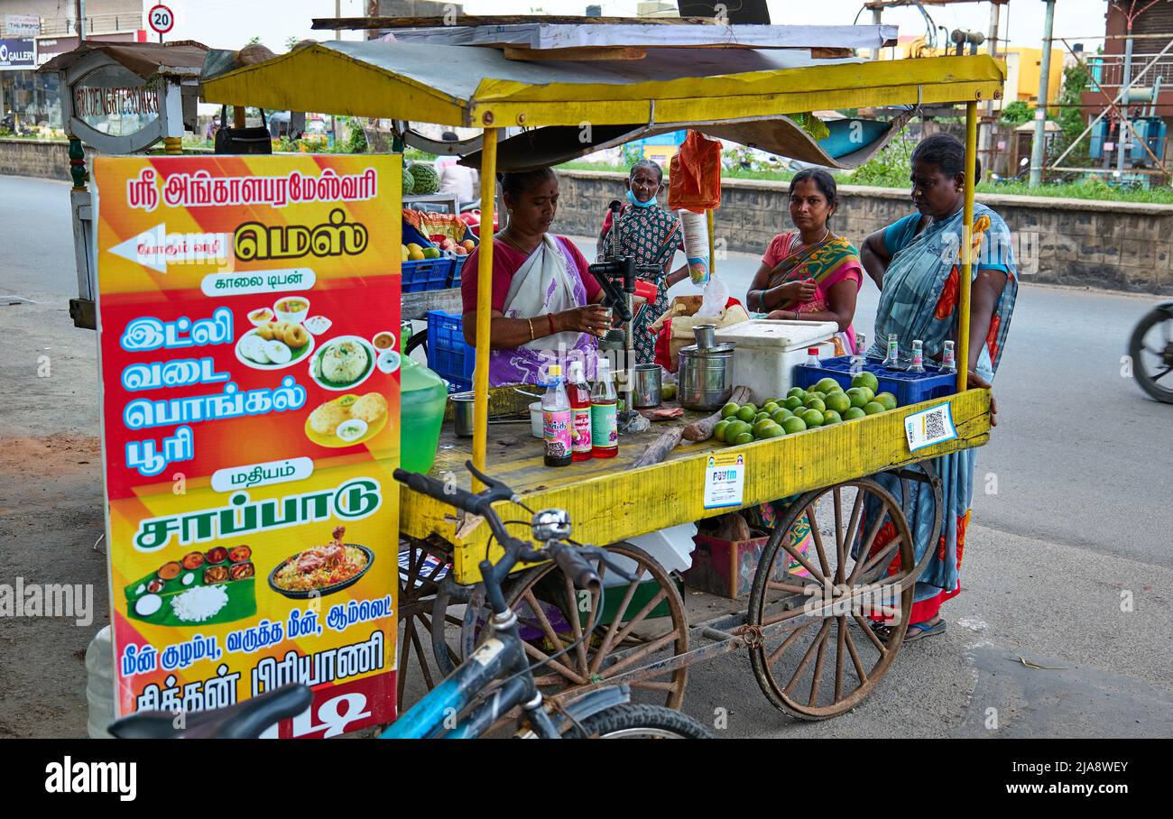 Indian women having juice on road side Stock Photo Alamy