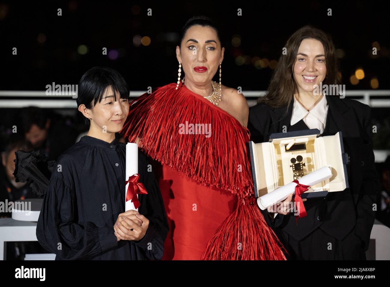 President of the Camera d'or jury, Rossy De Palma (C) poses with Director Chie Hayakawa who won the Special Mention for a first film winner for Plan 75 and Director Gina Gammell who won the Caméra d’or Award for a first film for War Pony during the 75th annual Cannes film festival at Palais des Festivals on May 28, 2022 in Cannes, France. Photo by David Niviere/ABACAPRESS.COM Stock Photo