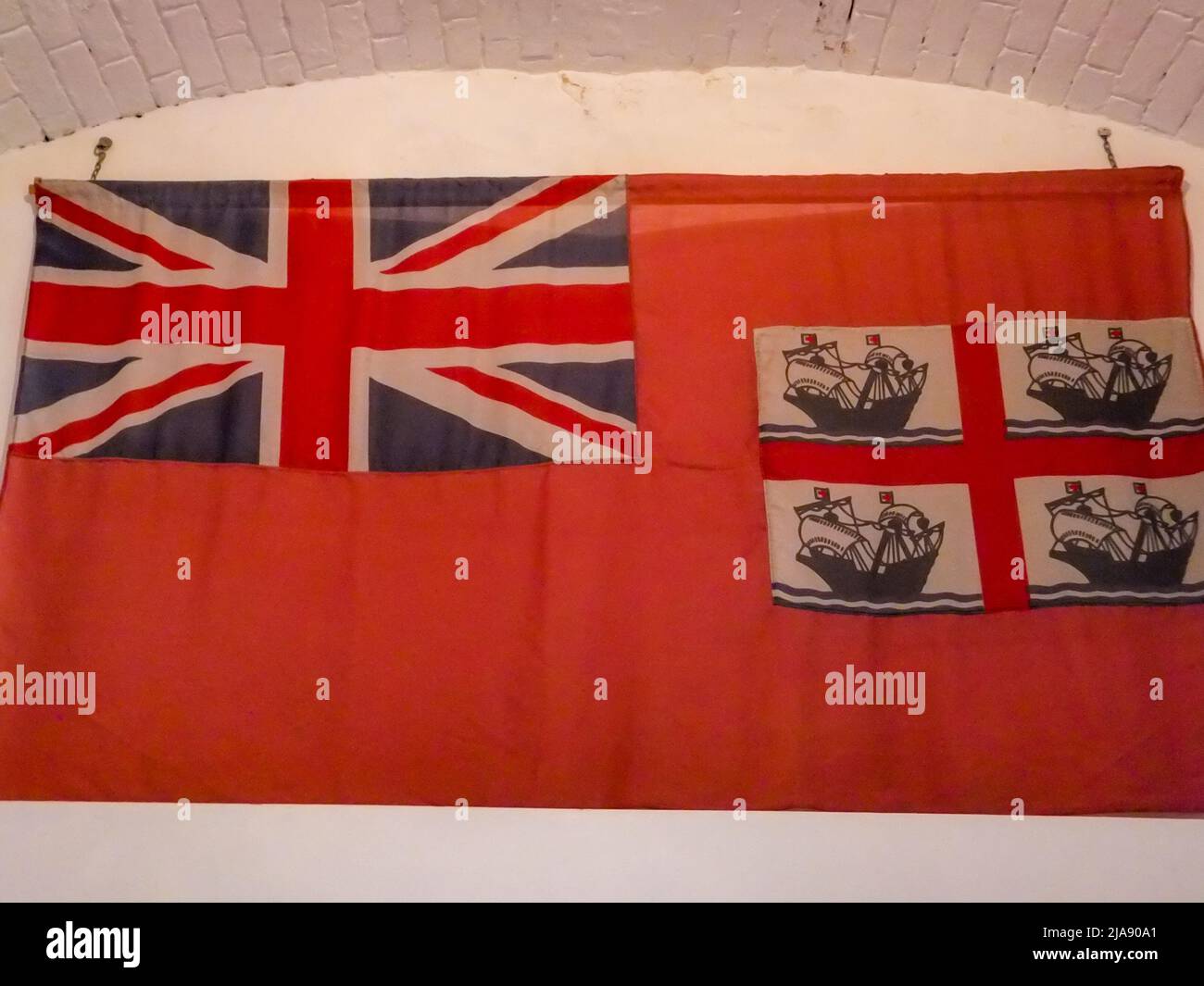 A British 'red ensign' flag defaced with four ships is on display at Hurst Castle in Milford-on-Sea, Hampshire, England, UK. Stock Photo