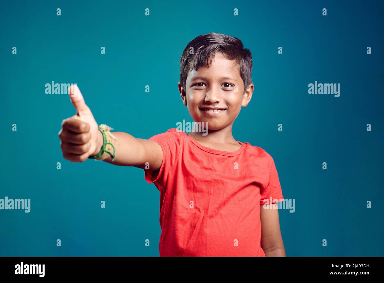 Preteen boy showing thumbs up. Asian boy 8-10 years old. Stock Photo