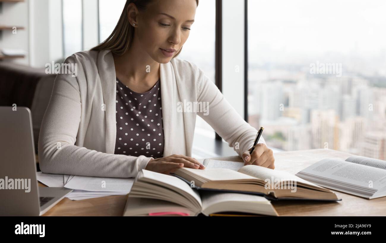 Serious hardworking millennial adult student preparing for exam Stock Photo
