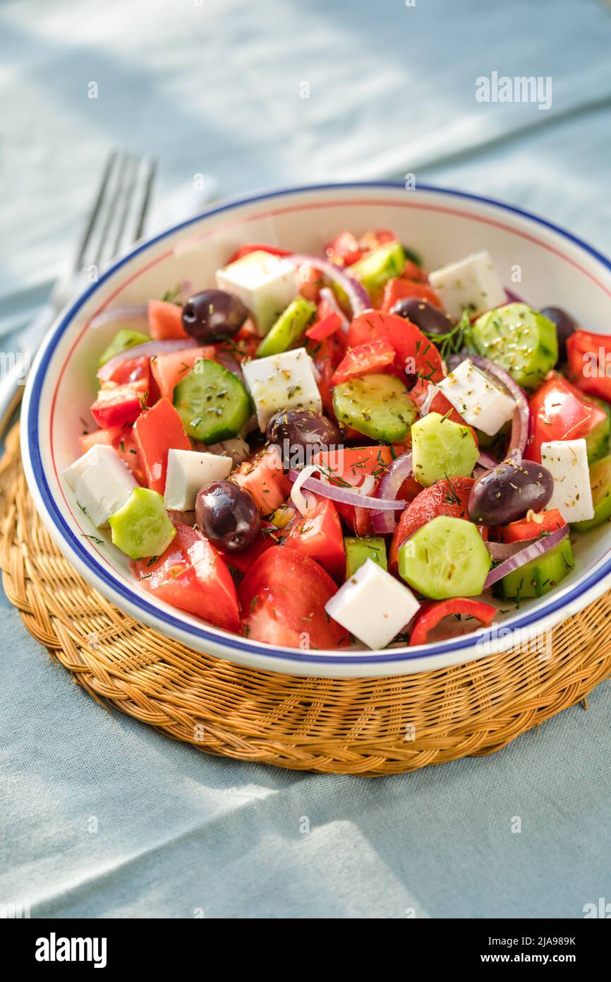 Greek salad with feta cheese, olives, tomato, cucumber and red onion