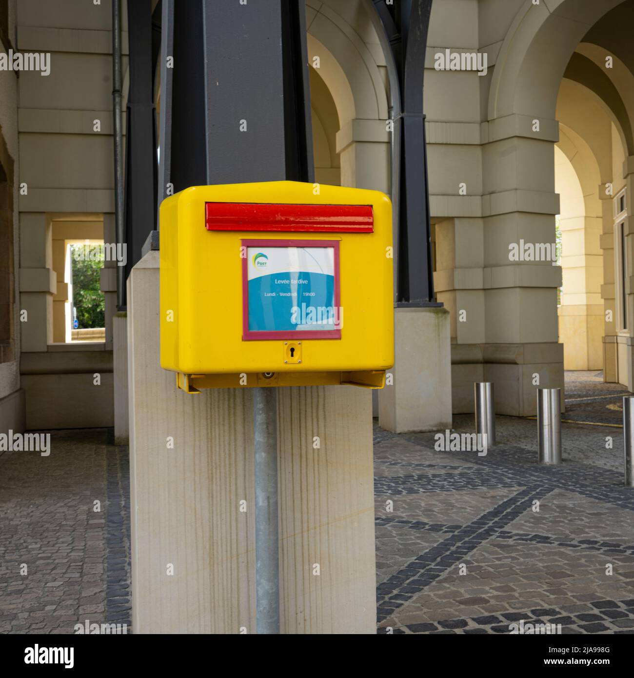 Luxembourg city, May 2022. the yellow postbox in a city center street Stock Photo