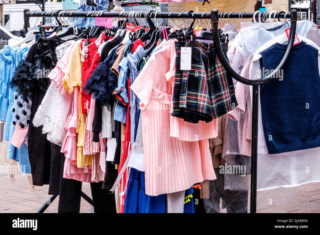 Epsom Surrey, London UK, May 28 2022, Fashion Clothing Hanging On A Rail In A Market Traders Stall Stock Photo