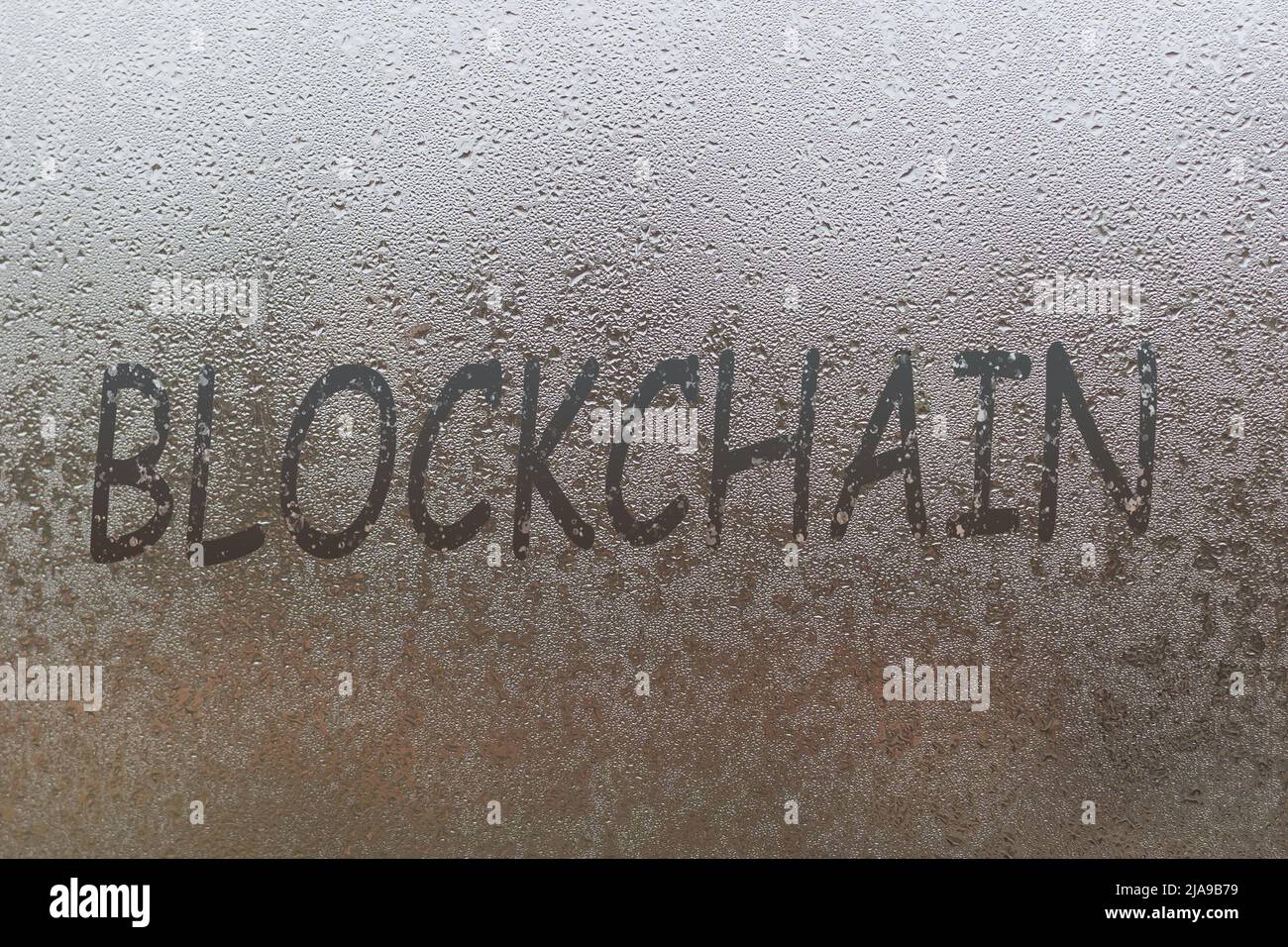 blockchain handwritten on wet glass of night window Stock Photo - Alamy
