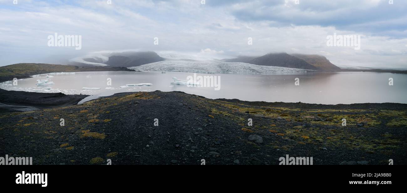 Glacier tongue end with lake and icebergs panorama Stock Photo