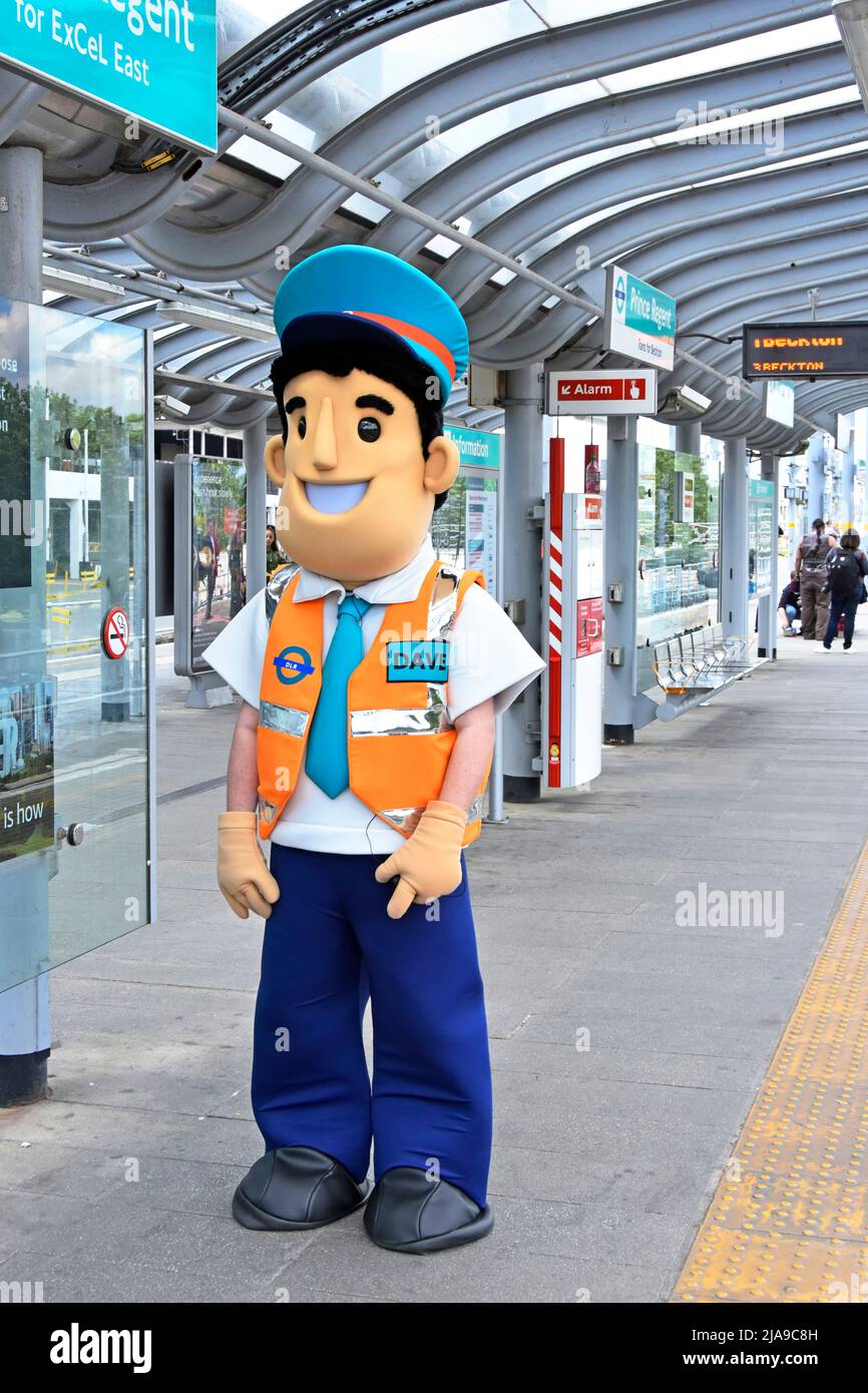 Docklands Light Railway station platform staff fun dressing up outfit help & welcome visitors to Excel Exhibition event Prince Regent DLR England UK Stock Photo