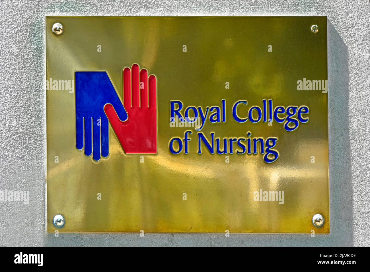 Close up brass name plate with logo at the Royal College of Nursing a registered nurses trade union headquarters in Cavendish Square London England UK Stock Photo