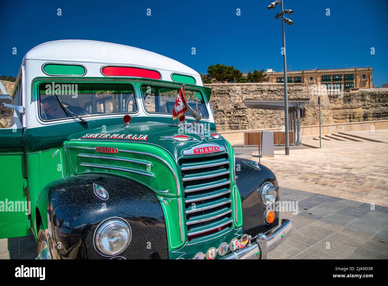 Valletta, Malta - April 17, 2022: Green touristic bus in the city center. Stock Photo