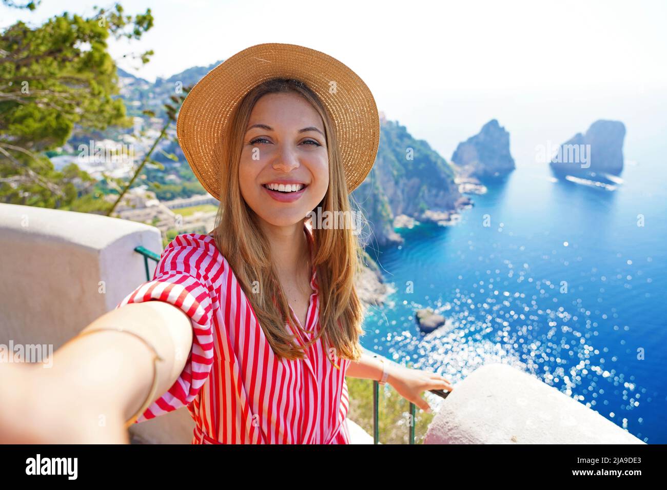 Capri beauty taking self portrait with Faraglioni sea stacks by Capri Island, Italy Stock Photo