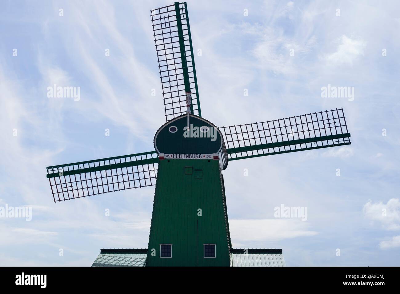 Traditional wooden windmill at Zaanse Schans museum, North Holland. Working windmills, tourist attraction. Stock Photo