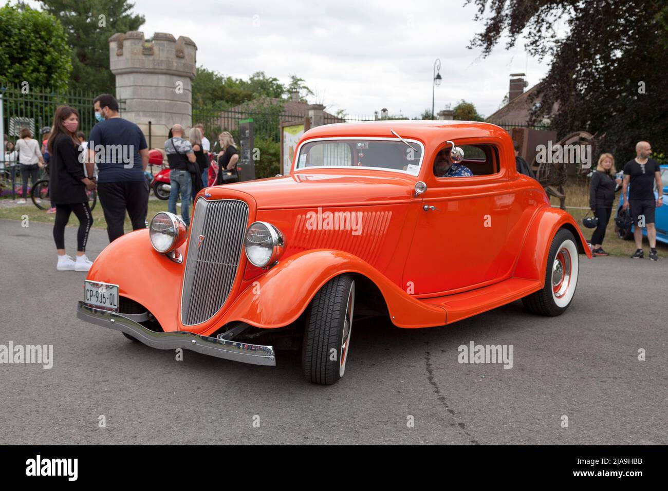 Lamorlaye, France - July 05 2020: Orange customised 1934 Ford Model 40 coupe 3 windows with a V8 engine. Stock Photo
