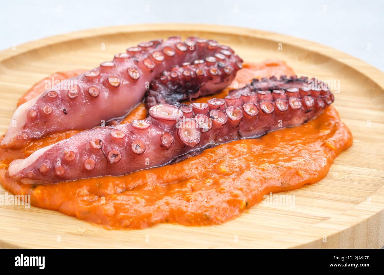 Roasted octopus tentacles with chilli romesco sauce Stock Photo