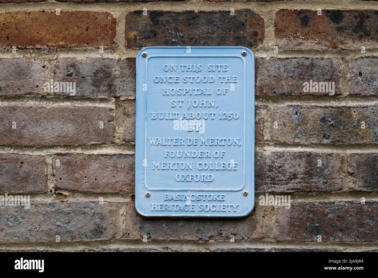 Plaque from Basingstoke Heritage Society on Church Street - 'On this site stood the hospital of St John, built about 1250 by Walter de Merton. England Stock Photo