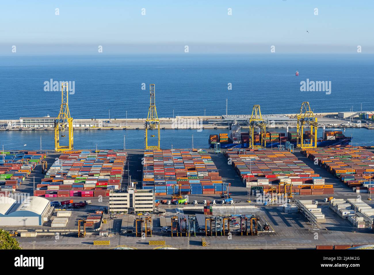 BARCELONA, SPAIN - February 02, 2022: The commercial harbour of Barcelona with containers and cranes Stock Photo
