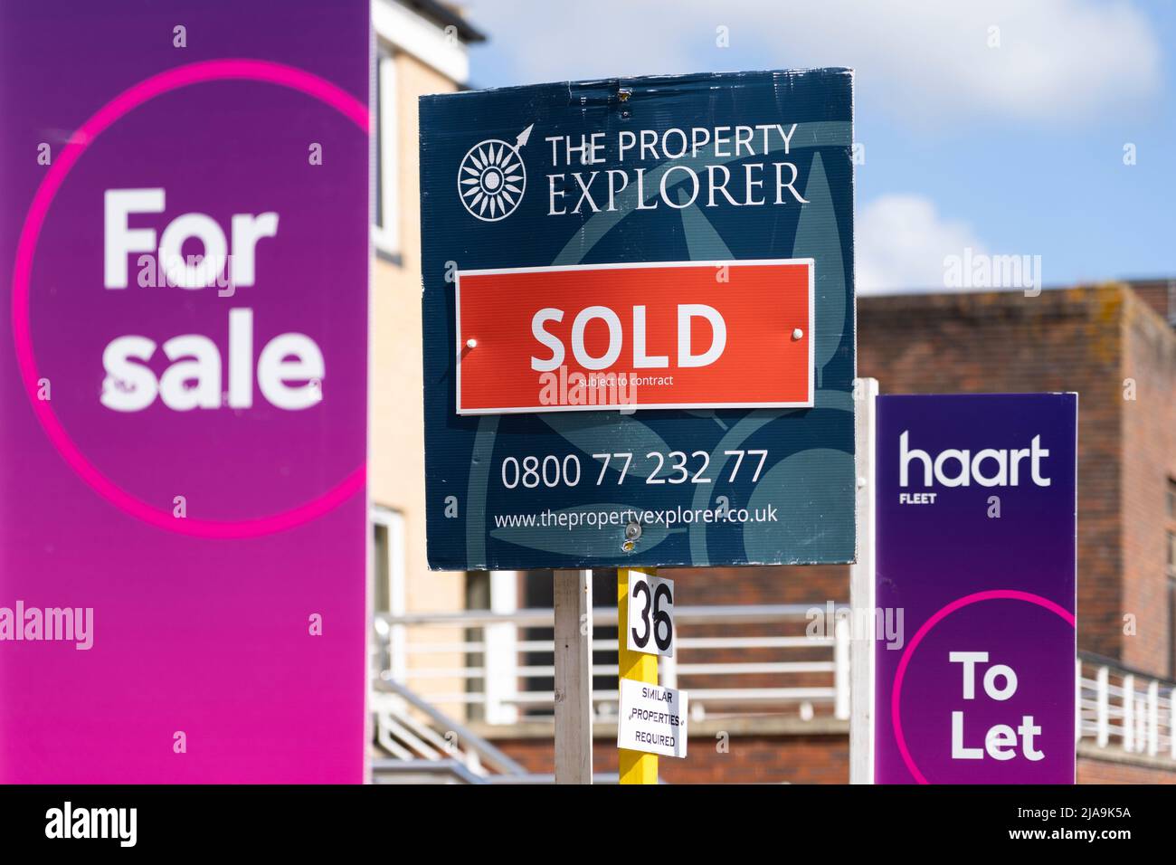 UK estate agent signs showing properties for sale and to let. Concept - housing market crash, average uk house price, property market, rising prices Stock Photo