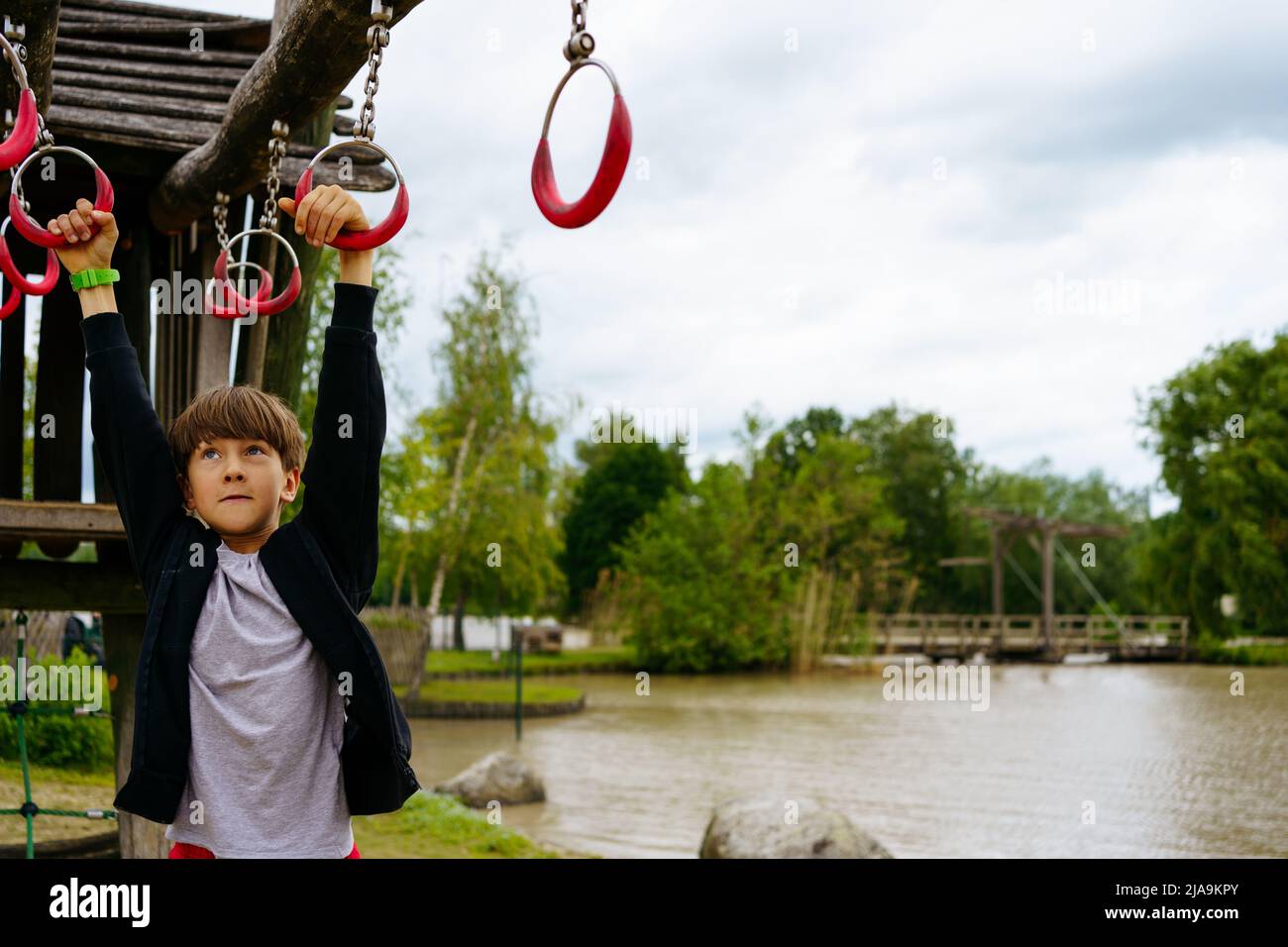 Climbing boy on the playground outside in center Parc in Niederlande