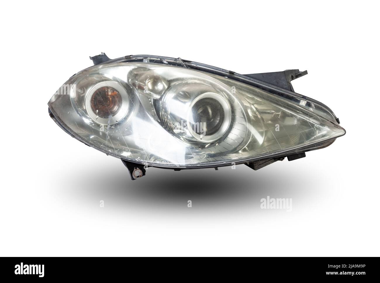 Stylish xenon headlight of a German car - optical equipment with a lamp inside on a white isolated background. Spare part for auto repair in a car wor Stock Photo