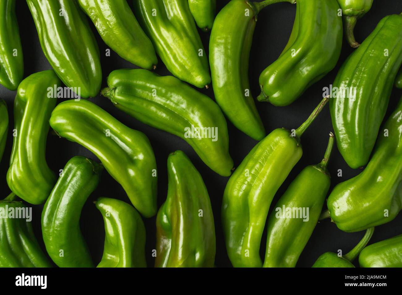 Close up of green peppers. Dark food photo of fresh peppers. Stock Photo