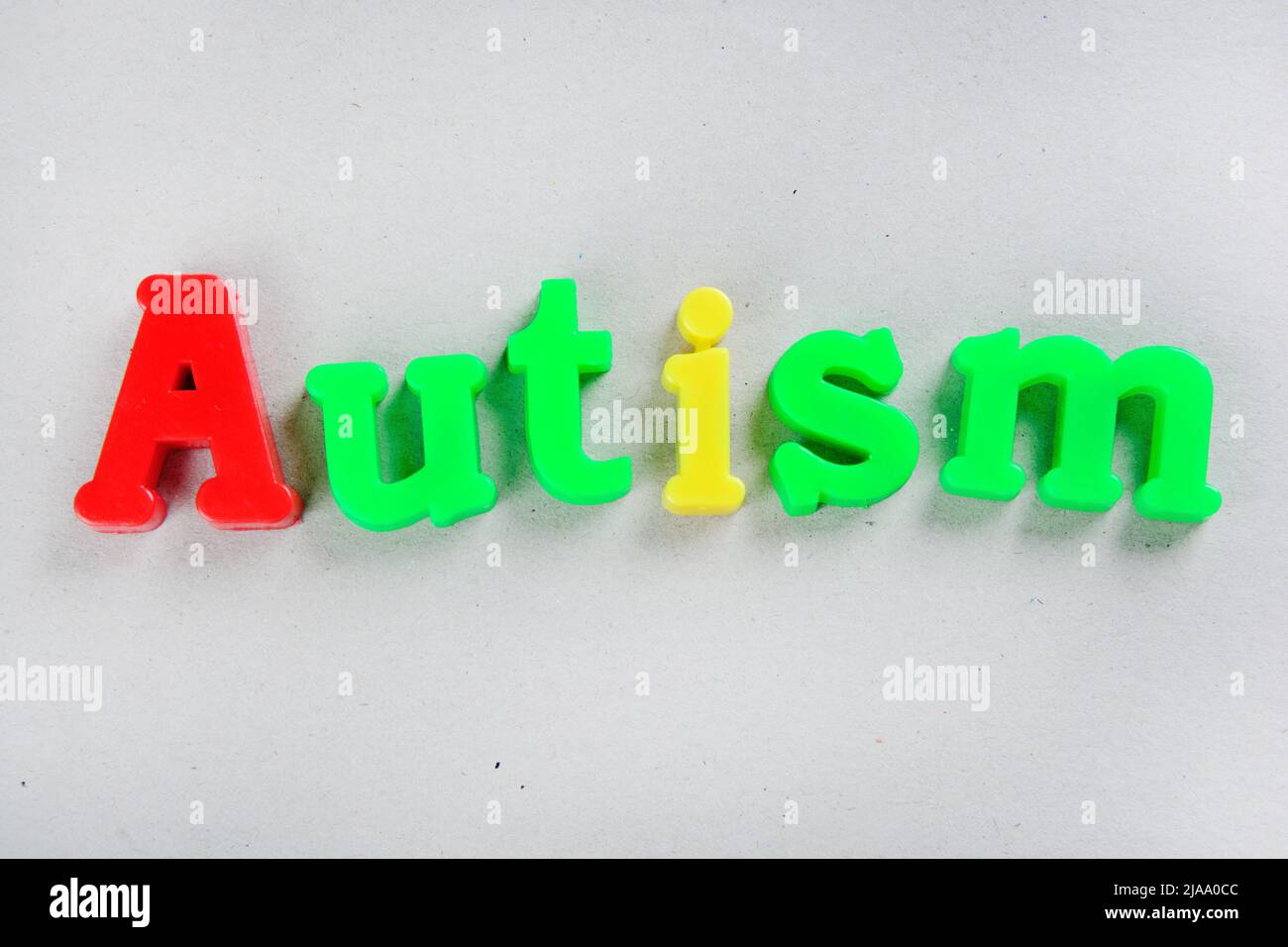 Autism word on a grey background. Top view Stock Photo