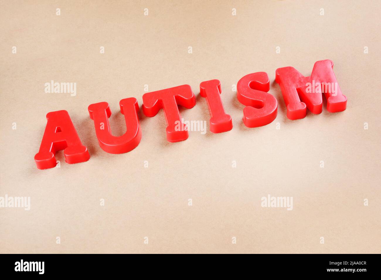 Word Autism made with red letters on background Stock Photo