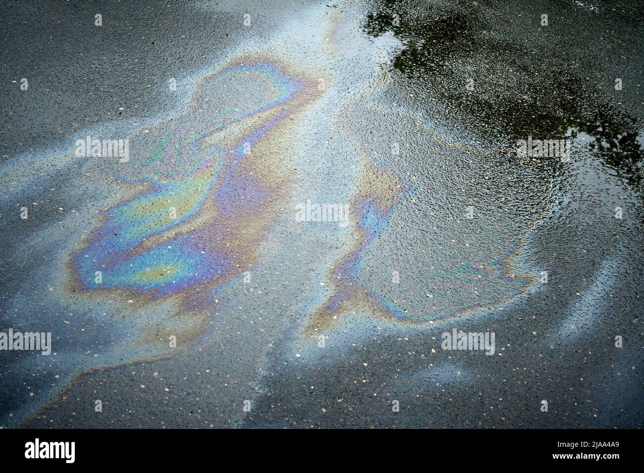 Gasoline oil spill on the pavement as a texture or background Stock