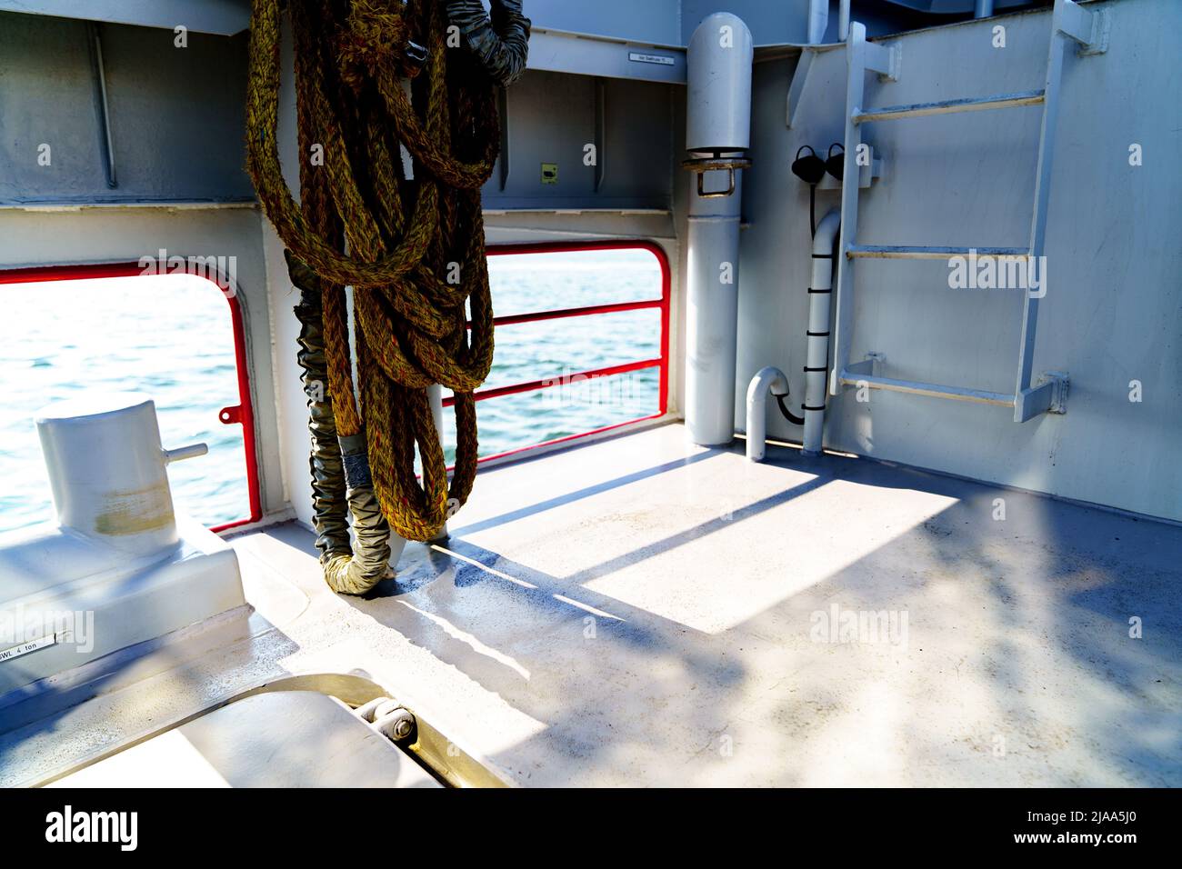 Storm Rails In Ship Ship railing on sunny deck with ropes Stock Photo - Alamy