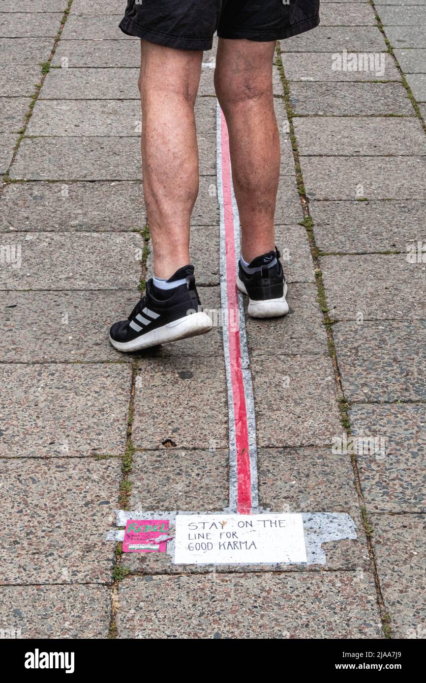 Germany,Berlin, Mitte,Weinbergsweg, September 2019. Pink rebel sticker Advertising the world global climate strike on September 20, 2019 just ahead of a UN emergency climate summit. Young people continue to alert the world to the alarming climate crises in their ‘Fridays for the Future’ protests. Slogan on pavement says 'Stay on the line for good Karma' Stock Photo
