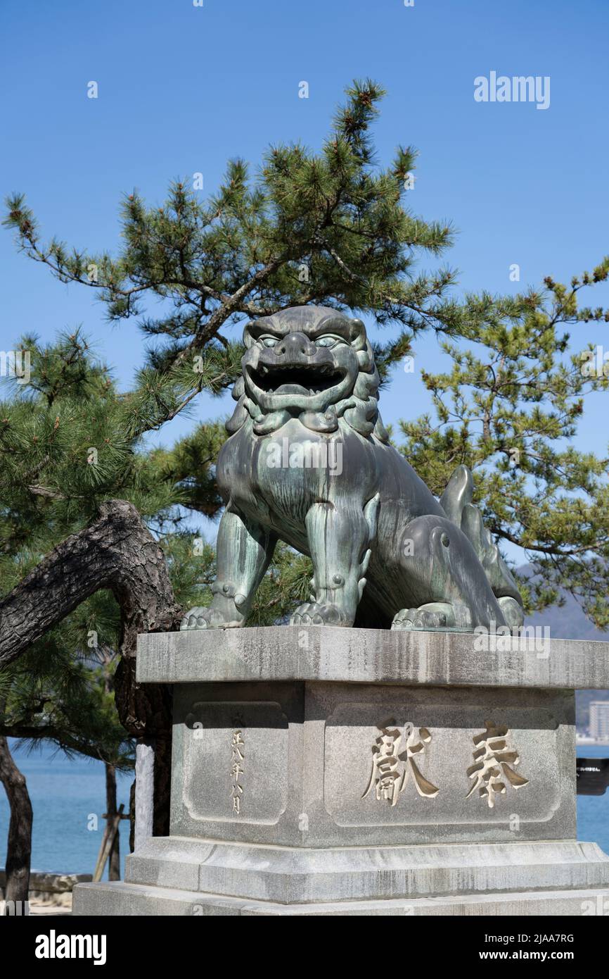 Komainu (lion-like guardiands) on Miyajima Island aka Itsukushima, Hiroshima Bay, Western Honshu, Japan Stock Photo