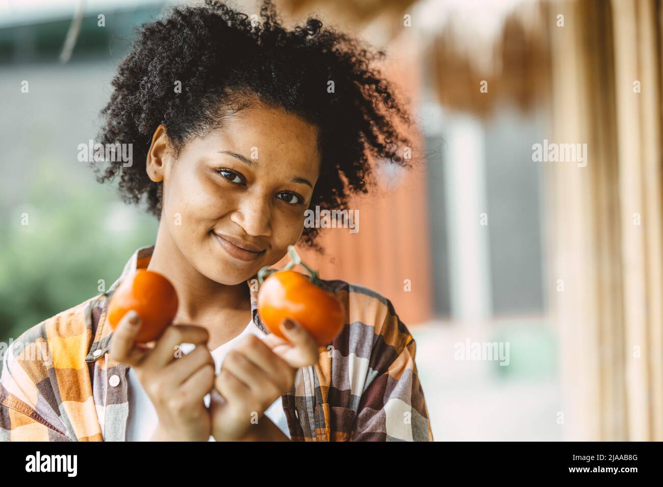 african black teen girl portrait with tomato healthy vetetable food for high vitamin Stock Photo
