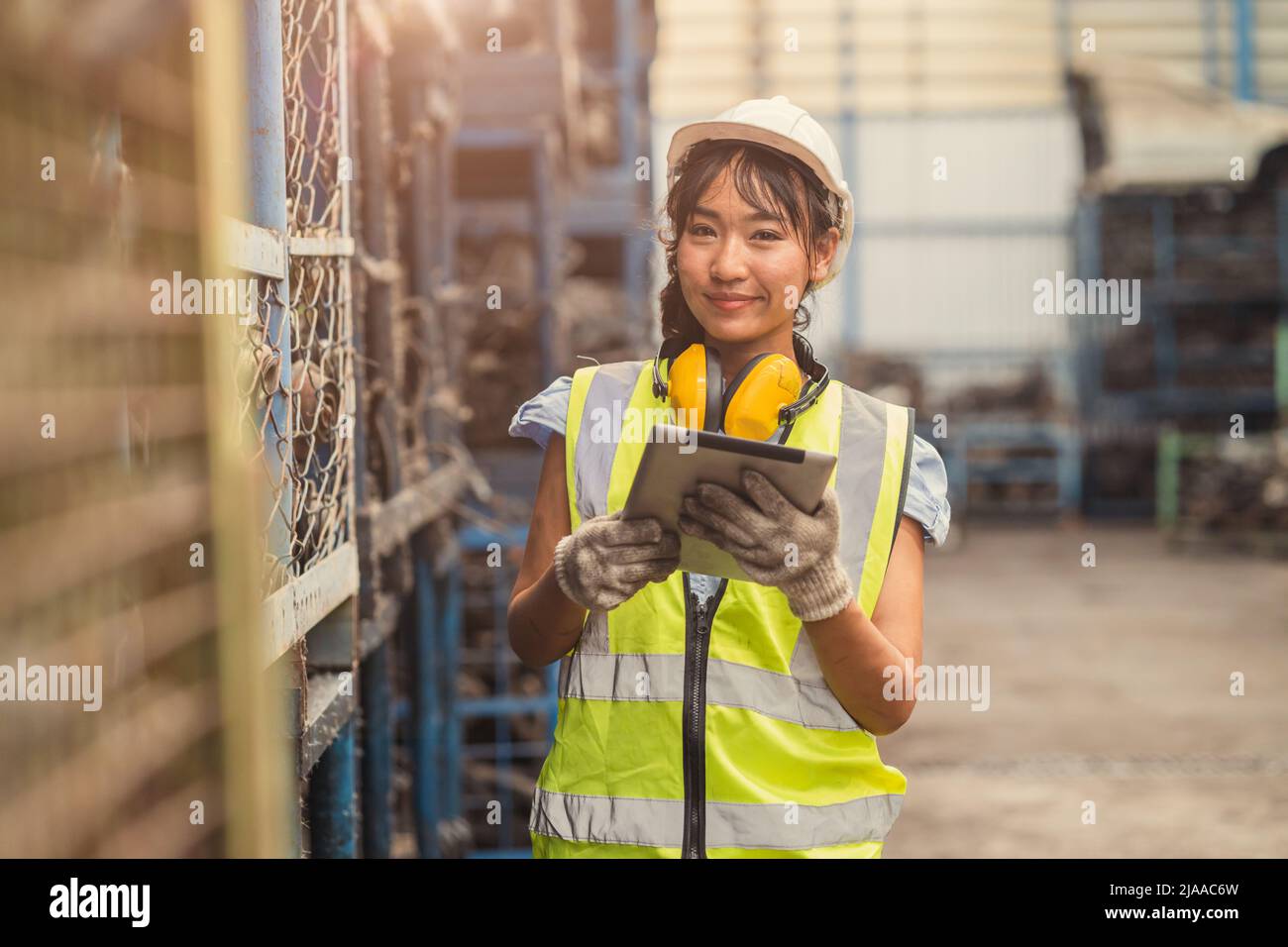 Engineer woman worker, Asian working women happy smiling in heavy industry dirty machinery factory. Stock Photo