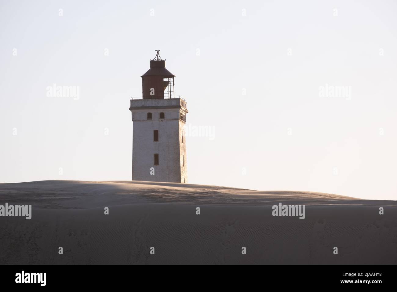 Rubjerg Knude Fyr Lighthouse in the sand dunes in northern denmark north jutland region at sunset Stock Photo