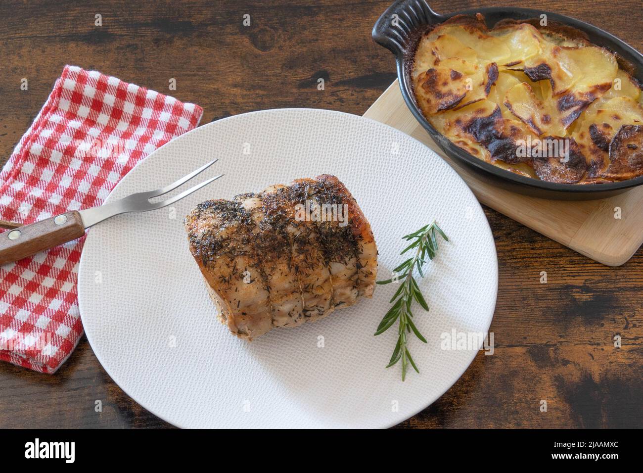 roast pork with gratin dauphinois on a table Stock Photo - Alamy