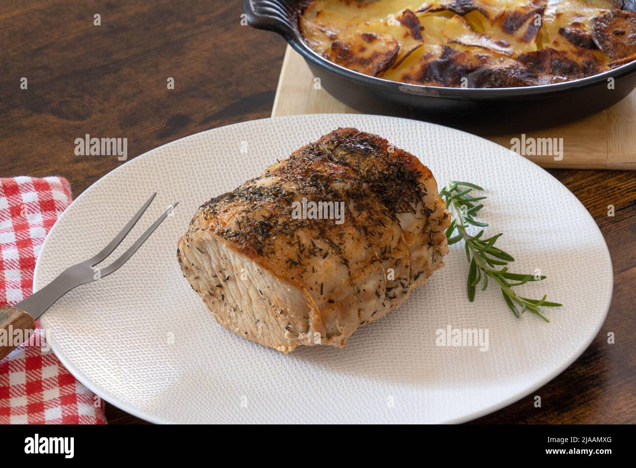 roast pork with gratin dauphinois on a table Stock Photo - Alamy